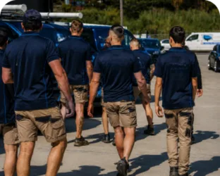 Plumbers walking to their service vans on a Luddenham job